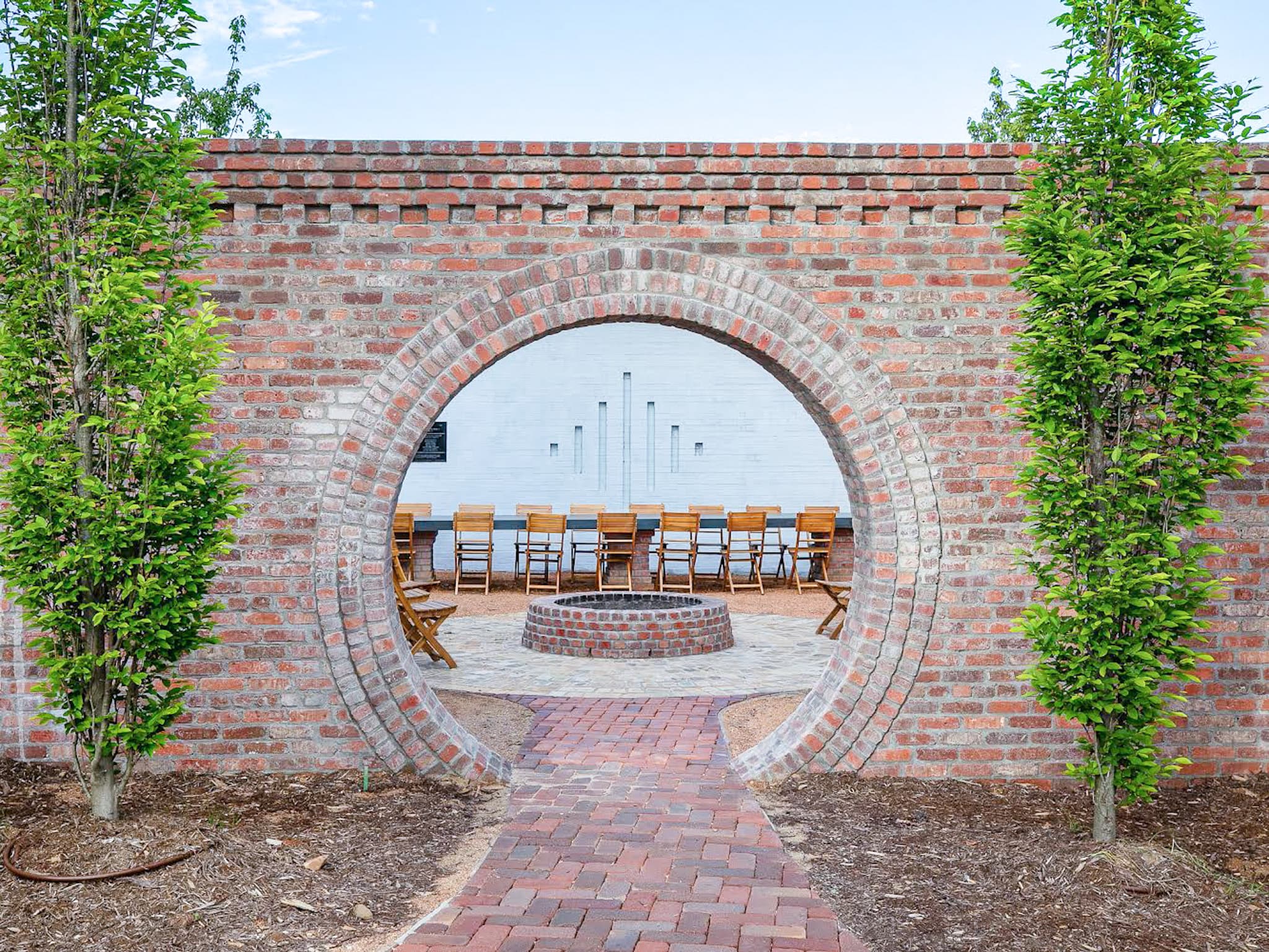 The brick moon-gate at The Bend at Carlton Landing, opening onto the central gathering courtyard