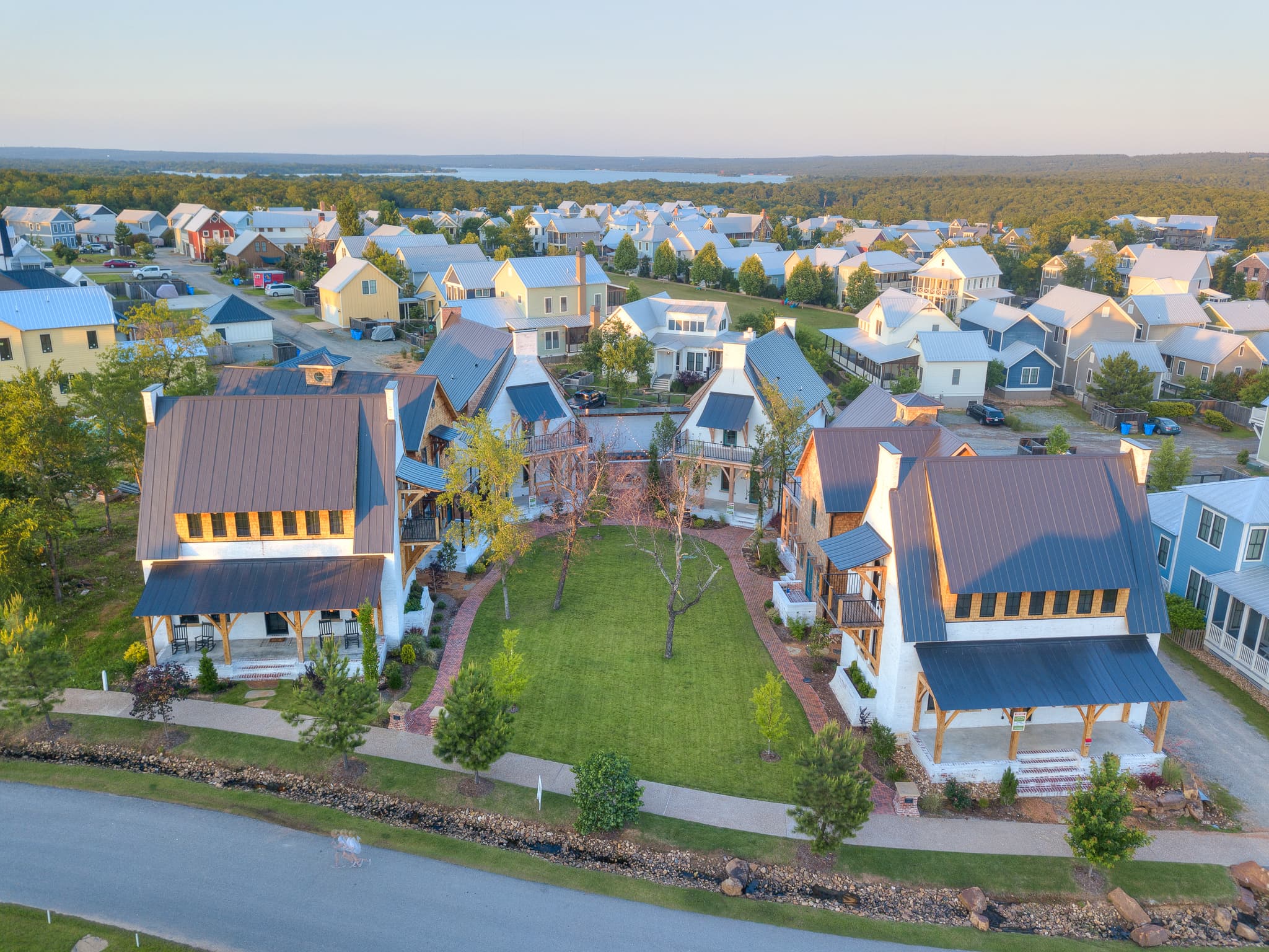 Aerial view of The Bend at Carlton Landing — the pocket neighborhood's central courtyard at sunset, lake in the distance