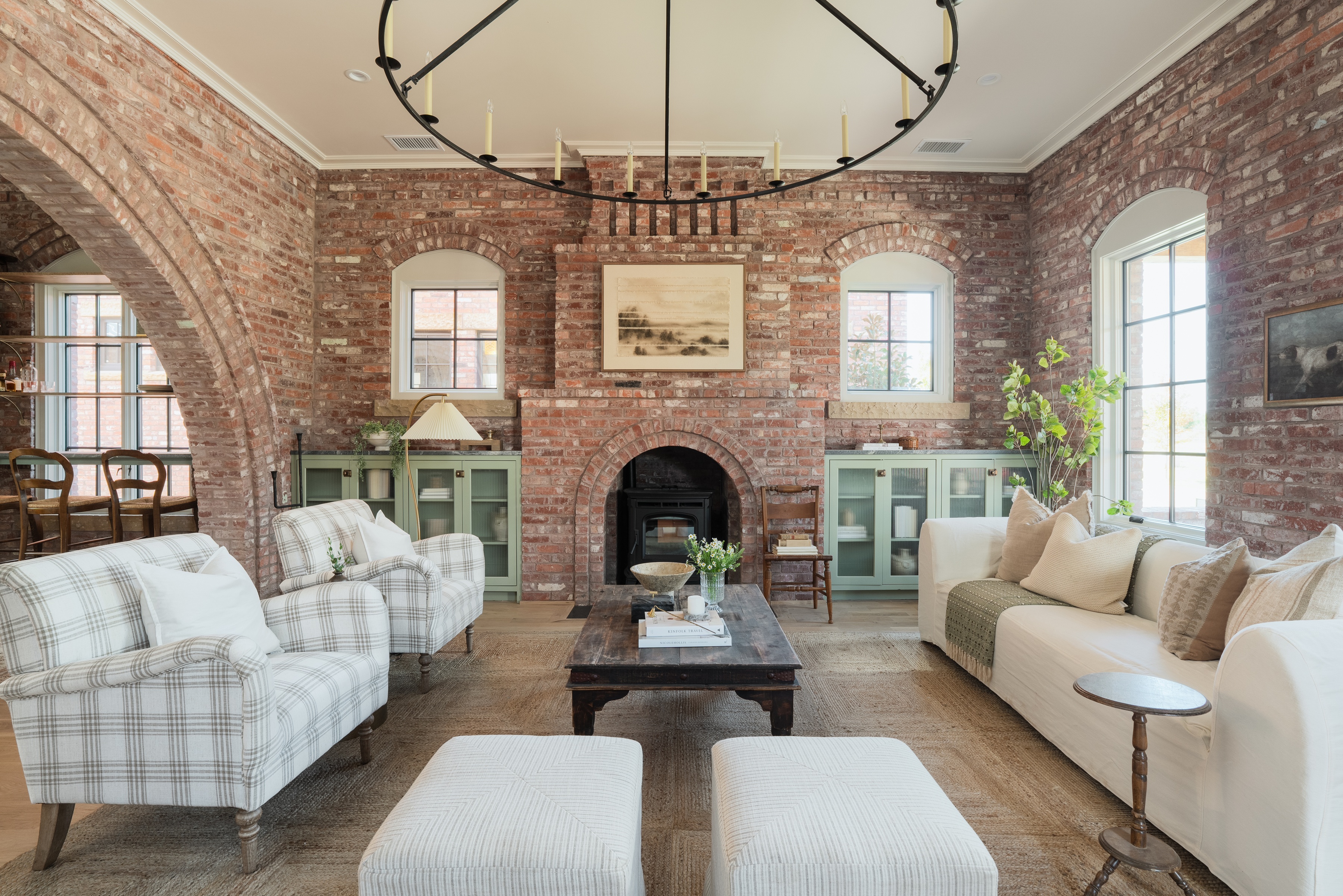 1900 Oso Ave — living room with exposed brick arched windows, masonry fireplace, and refined interior detail